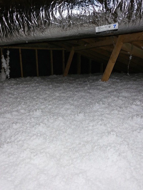 Fresh blown-in attic insulation after installation